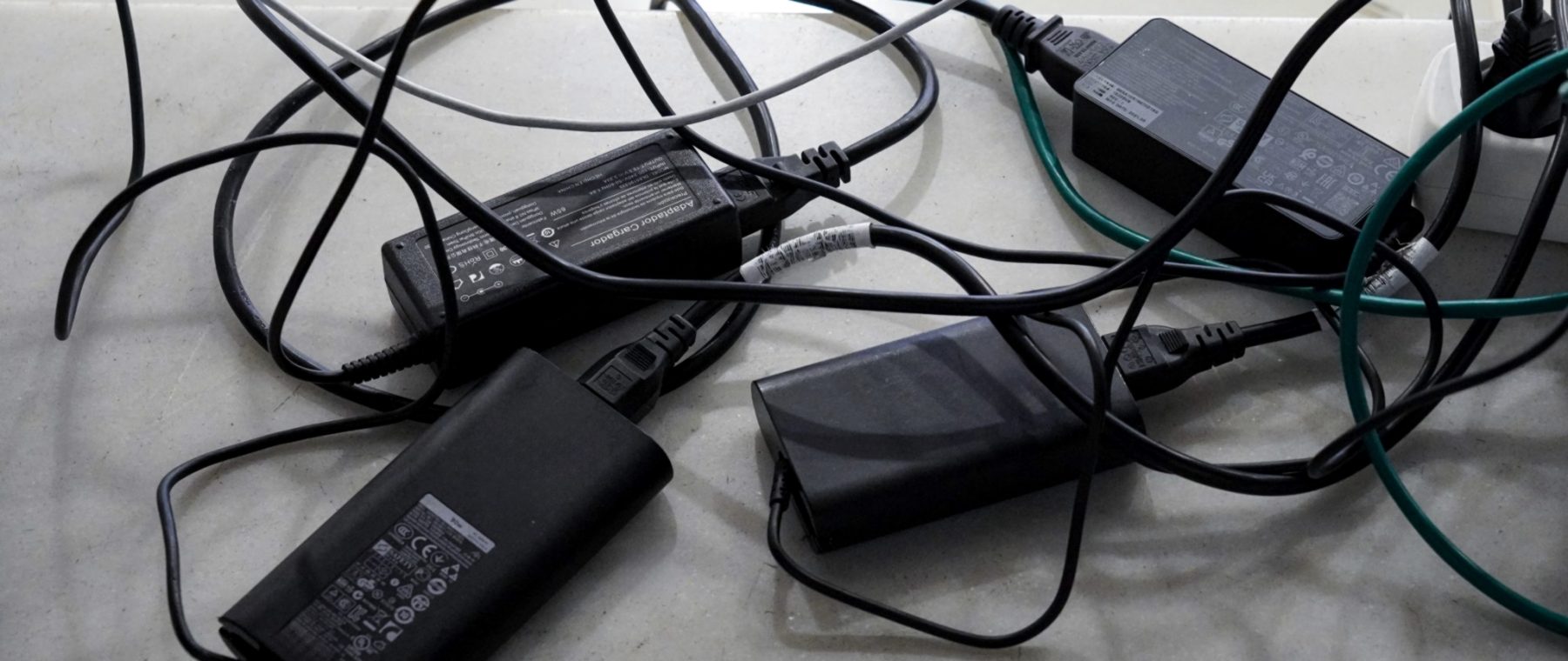Power adapters and cables on a work surface